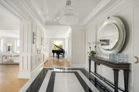 a view of an entryway with wooden floor