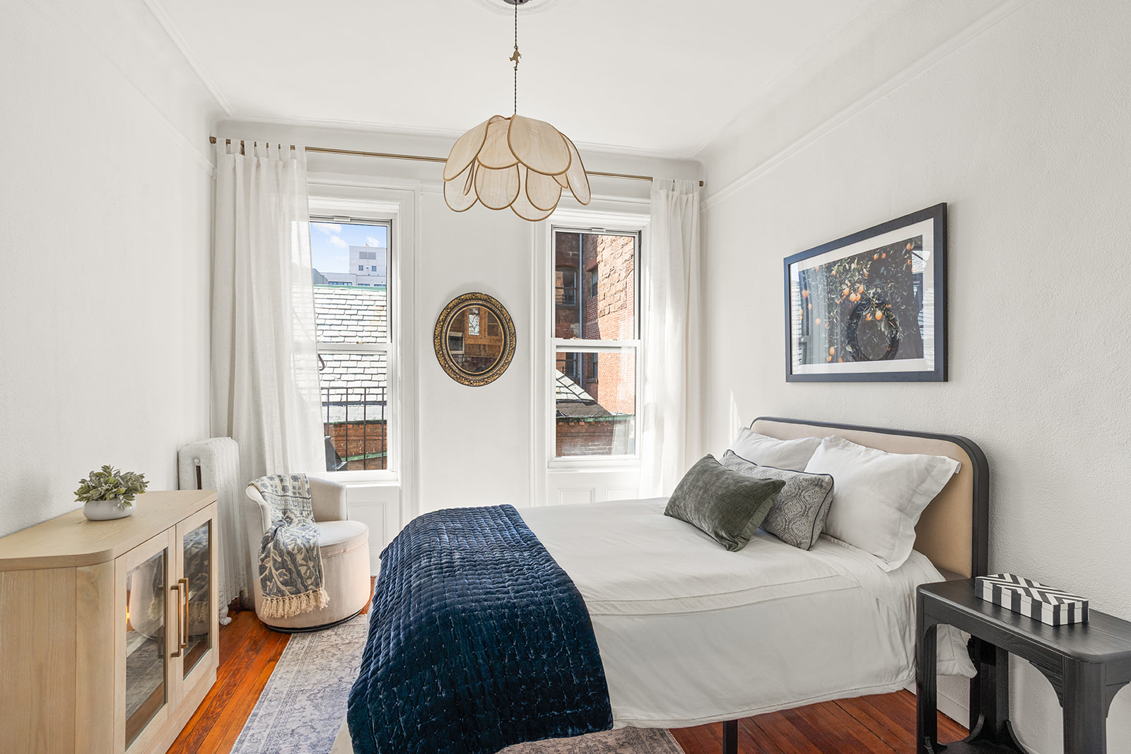 210 East 17th Street, Unit 5C Manhattan, NY 10003 - Photo 2 of 18 a bedroom with a bed a mirror and dresser