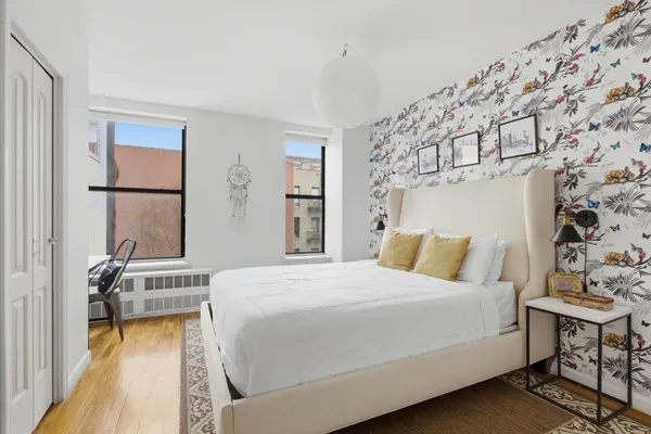 a bedroom with furniture a fireplace and a window