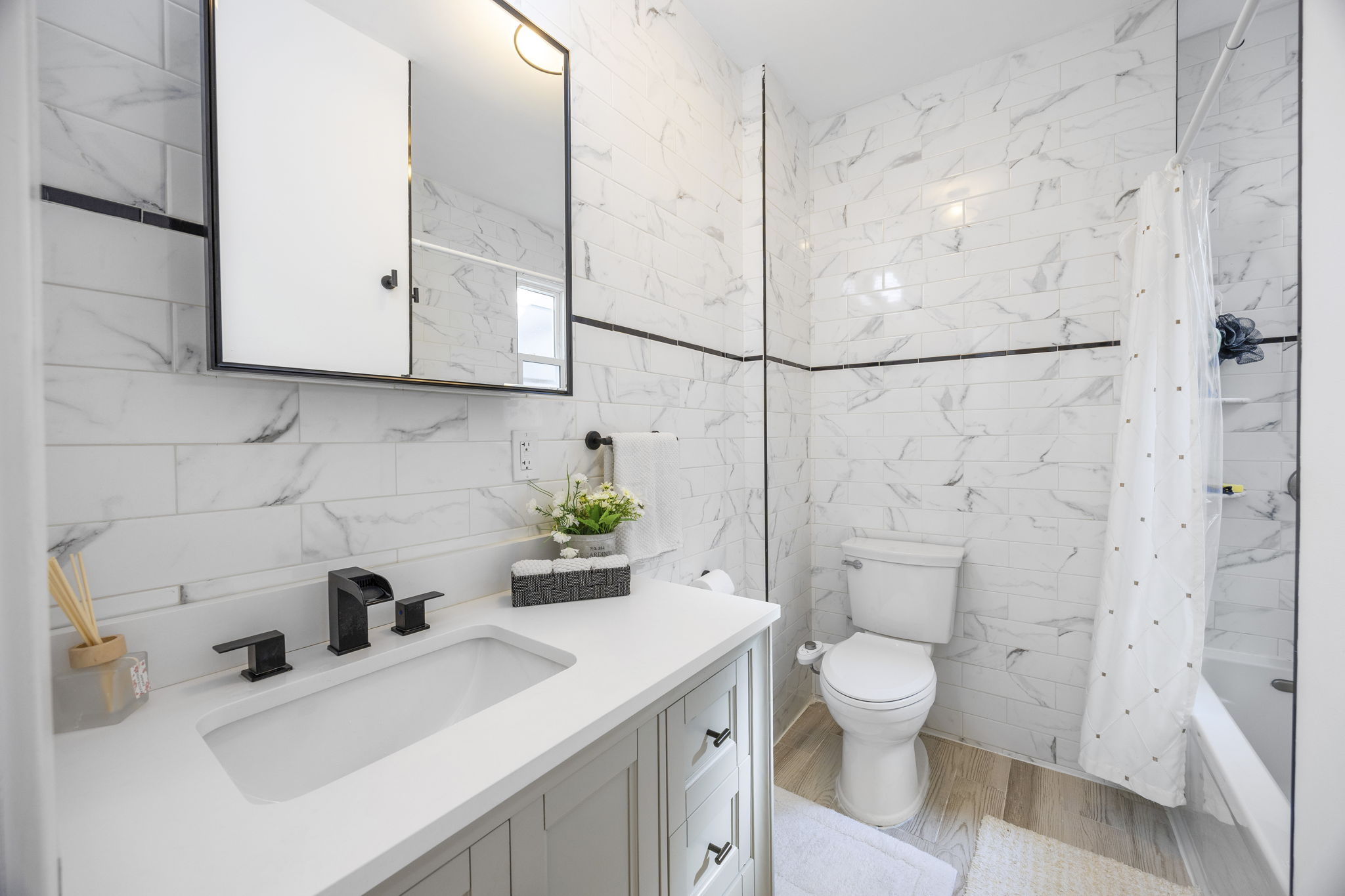 25-69 46th Street, Unit 2 Queens, NY 11103 - Photo 7 of 13 a bathroom with a sink a toilet and shower