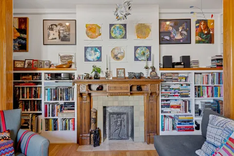 a living room with furniture and a bookshelf
