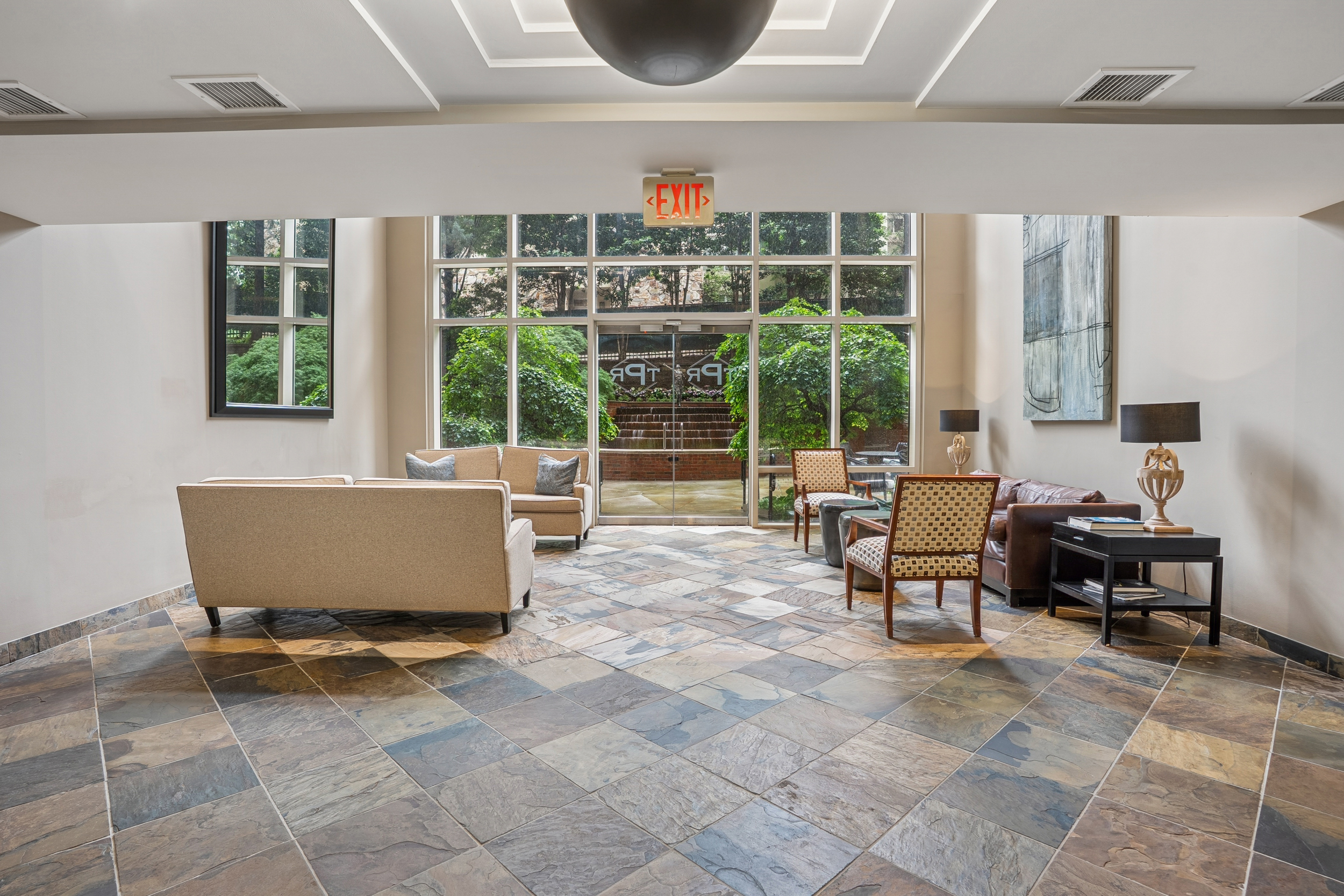 2626 Peachtree Road, Unit 1108 Atlanta, GA 30305 - Photo 23 of 25 a living room with furniture a window and a potted plant