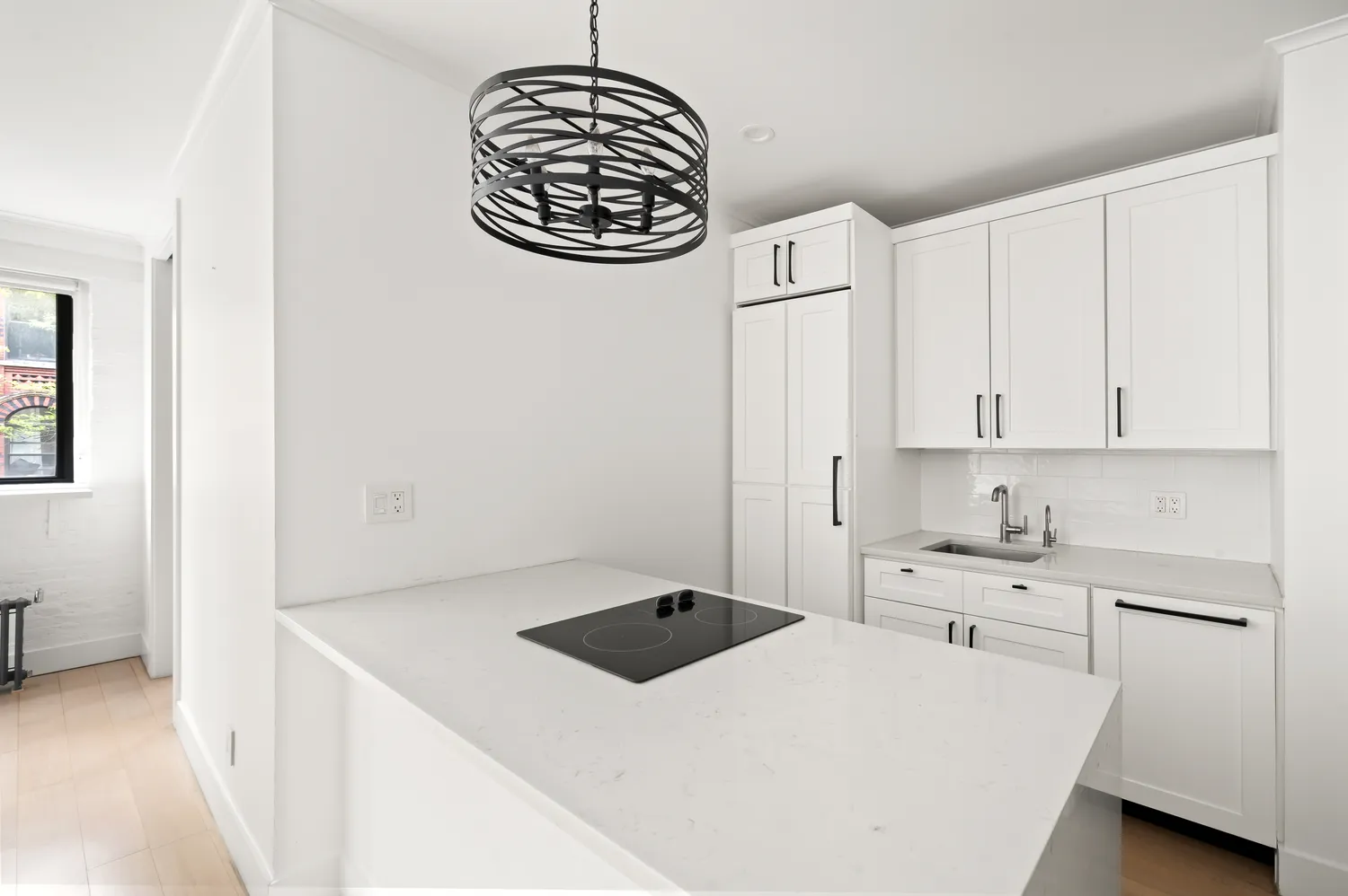 a kitchen with a cabinets and chandelier