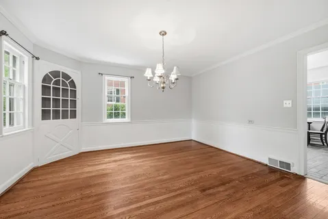 a view of hallway with wooden floor