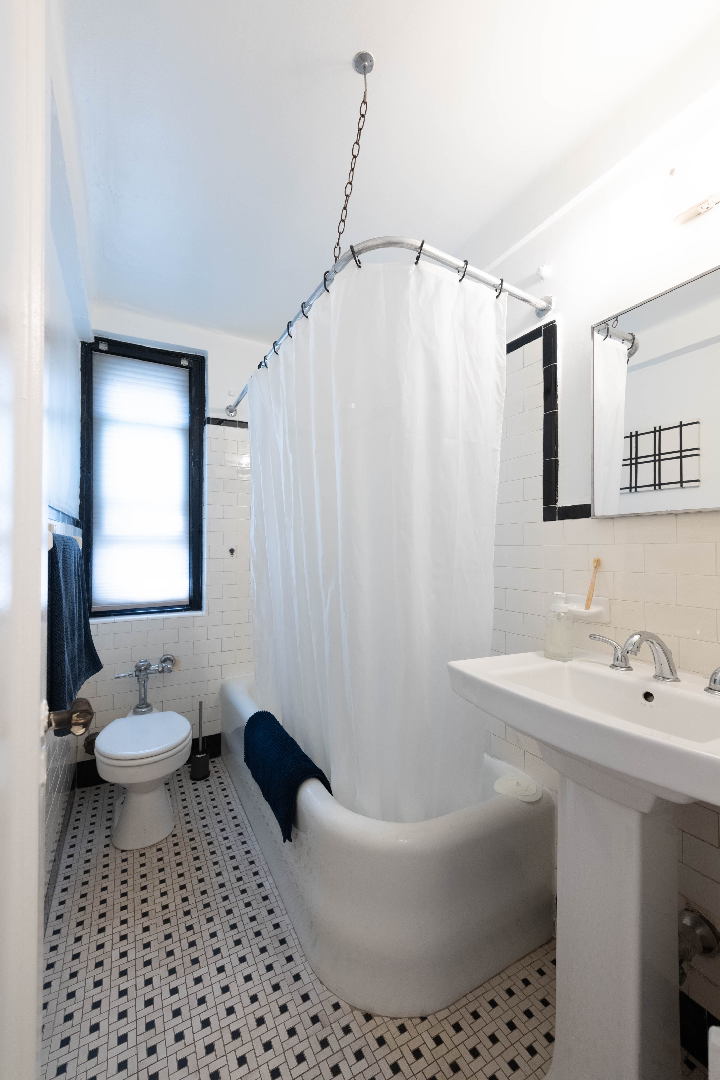339 East 58th Street, Unit 5B Manhattan, NY 10022 - Photo 8 of 13 a bathroom with a sink toilet and shower