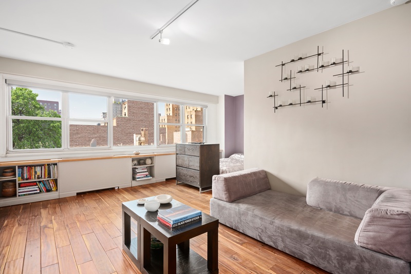 101 West 12th Street, Unit 9C Manhattan, NY 10011 - Photo 1 of 8 a living room with furniture and window with wooden floor