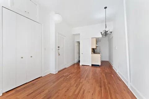 a view of a room with wooden floor