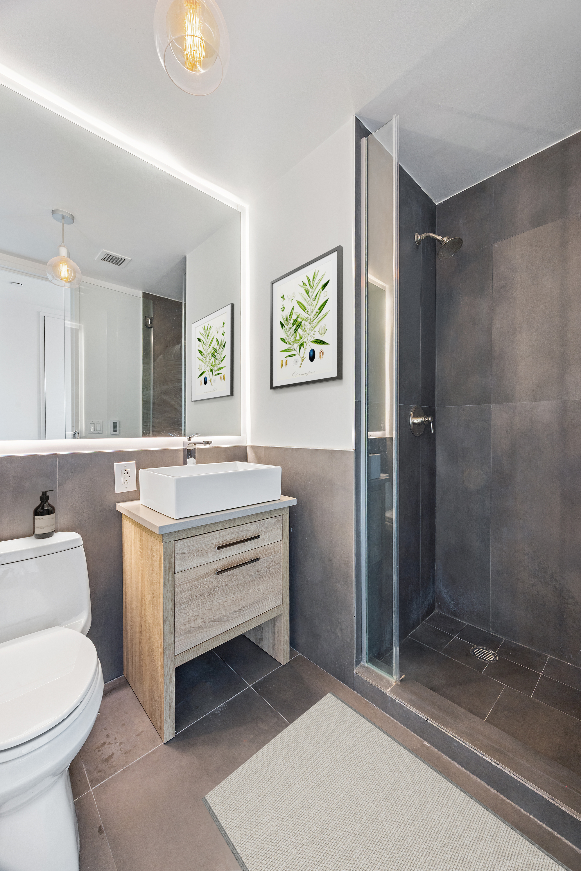 350 West 42nd Street, Unit 37G Manhattan, NY 10036 - Photo 13 of 14 a bathroom with a sink a toilet and shower