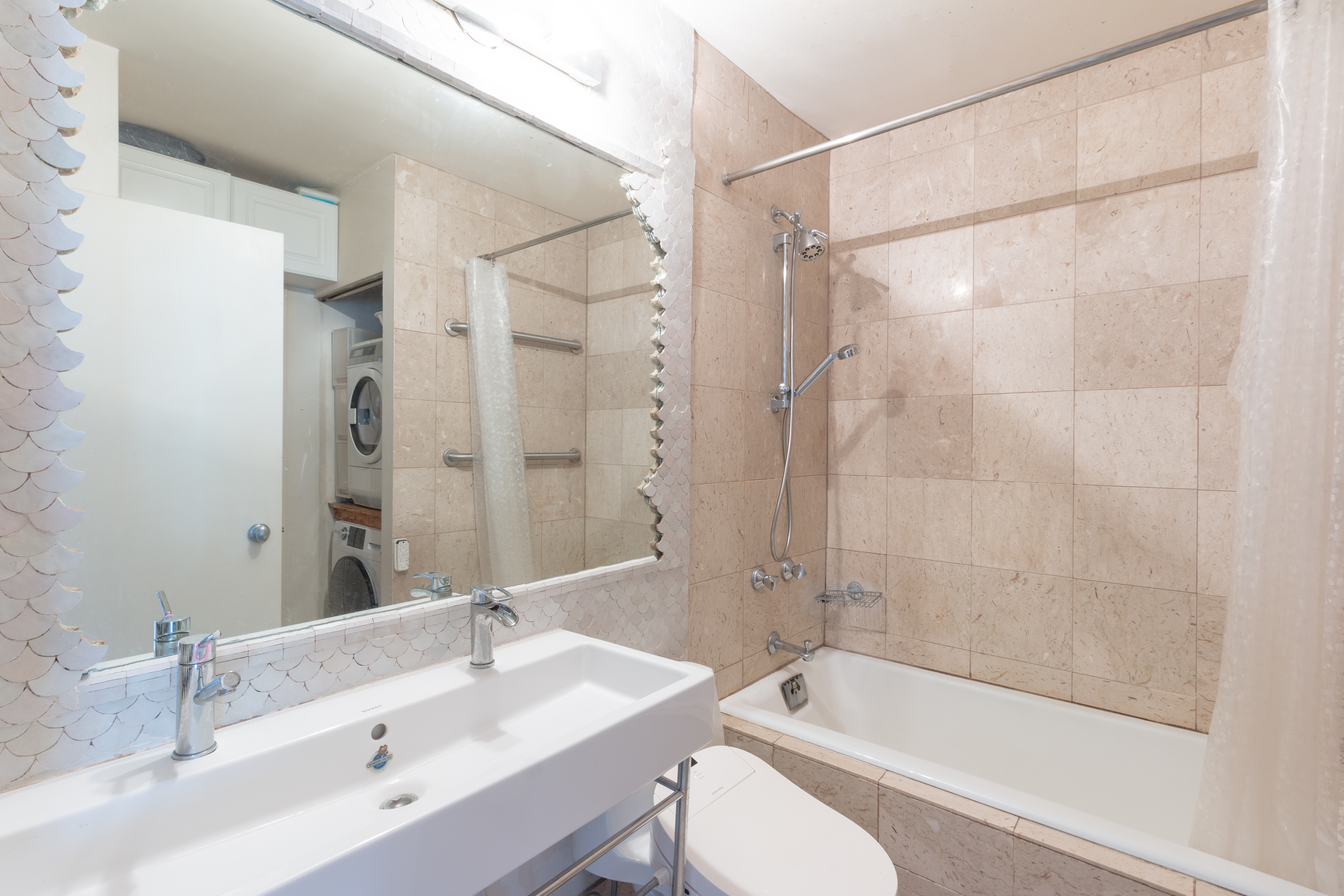 108 5th Avenue, Unit 15C Manhattan, NY 10011 - Photo 8 of 12 a bathroom with a sink shower bathtub and a toilet