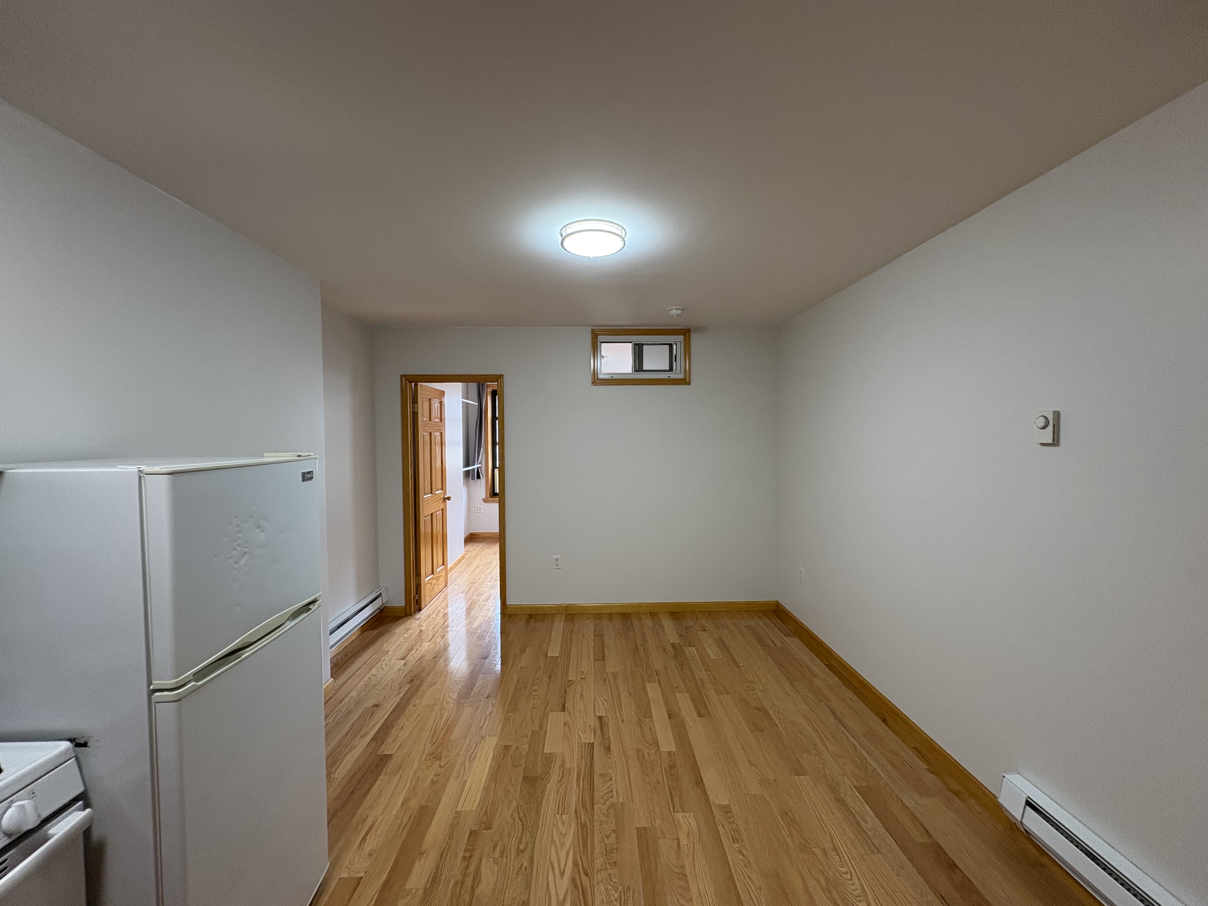 38 Ludlow Street, Unit 15 Manhattan, NY 10002 - Photo 5 of 16 a view of empty room with wooden floor