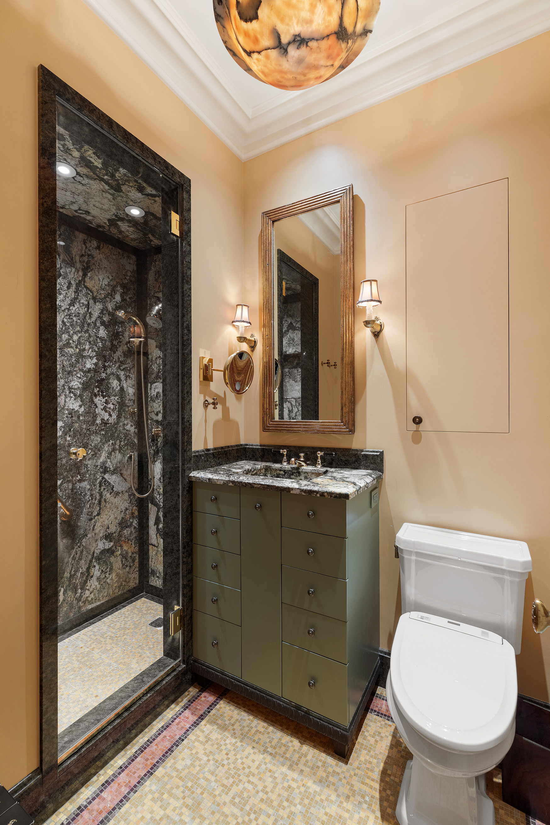 1 Central Park South, Unit 8010203 Manhattan, NY 10019 - Photo 20 of 45 a bathroom with a toilet a sink and mirror
