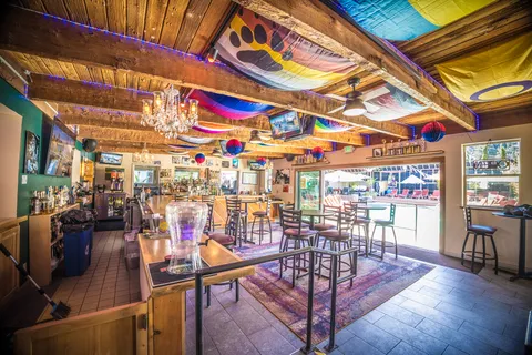 a large bedroom with a bed and wooden floor
