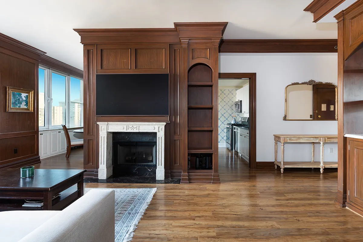 404 East 76th Street, Unit 30C Manhattan, NY 10021 - Photo 7 of 24 a living room with furniture and a fireplace