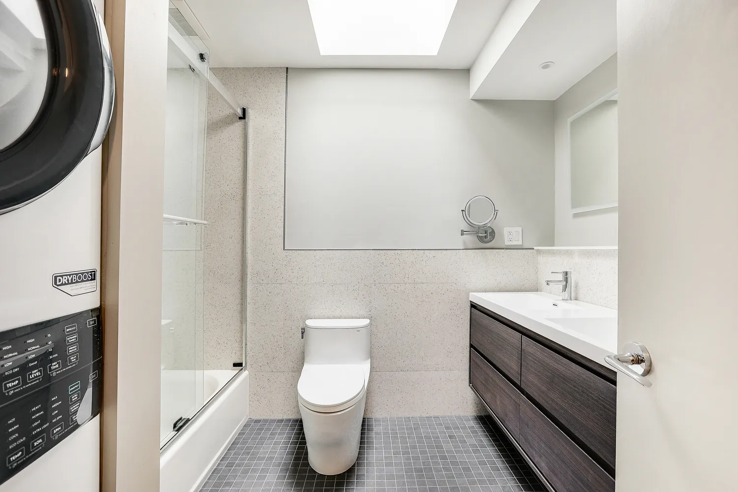 a bathroom with a sink a toilet and shower