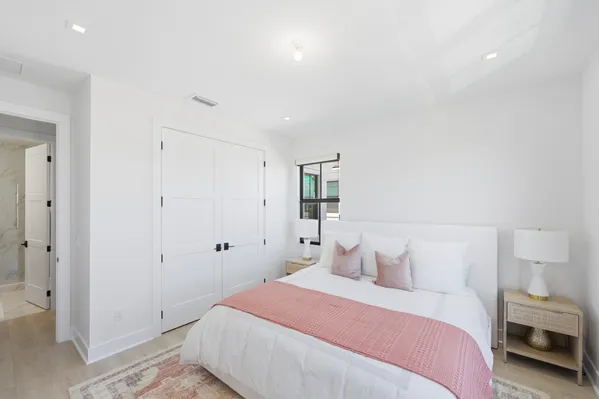 a bedroom with a bed and a chandelier
