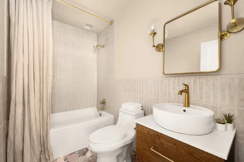 a bathroom with a sink a toilet and a mirror