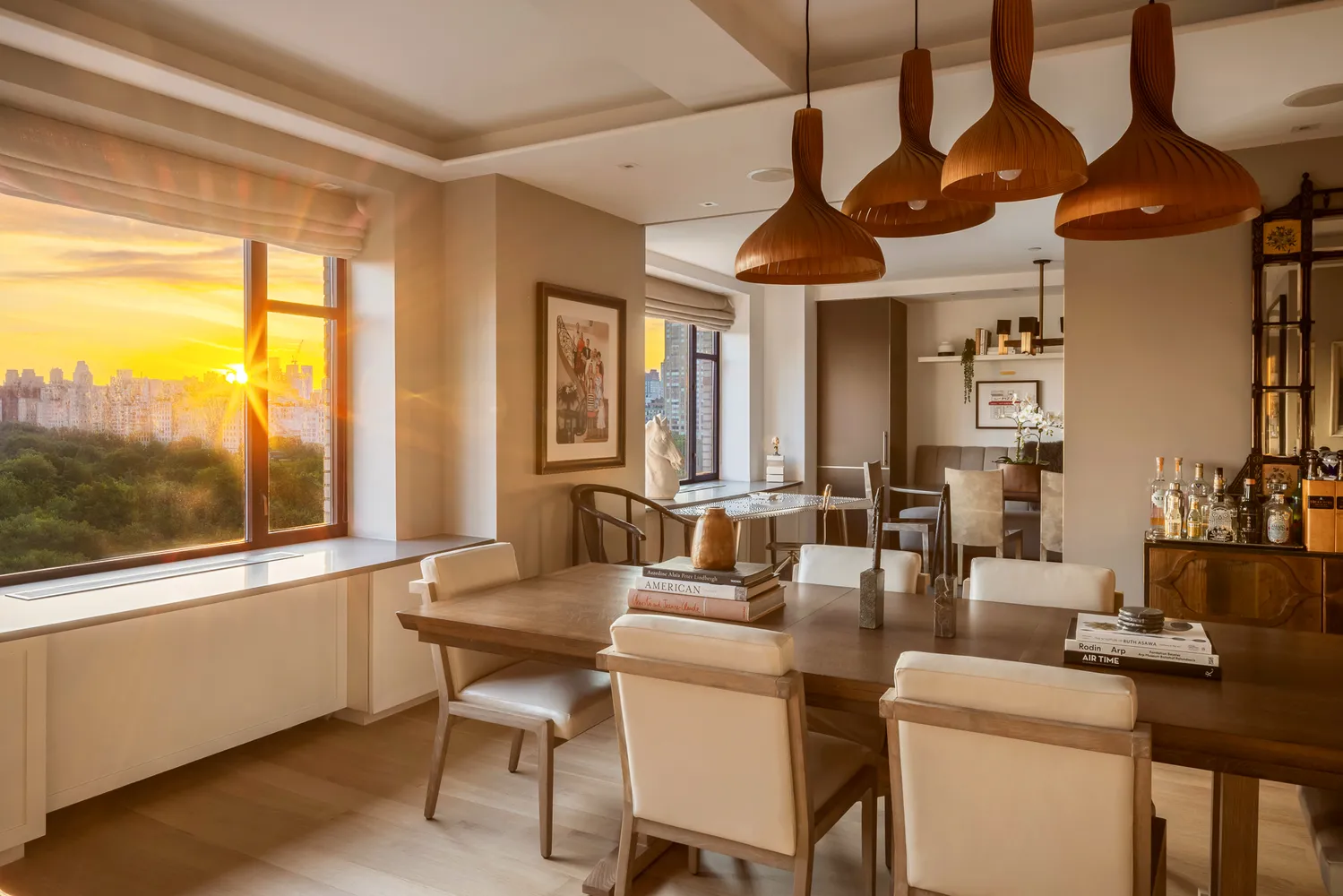 a dining room with furniture a chandelier and window