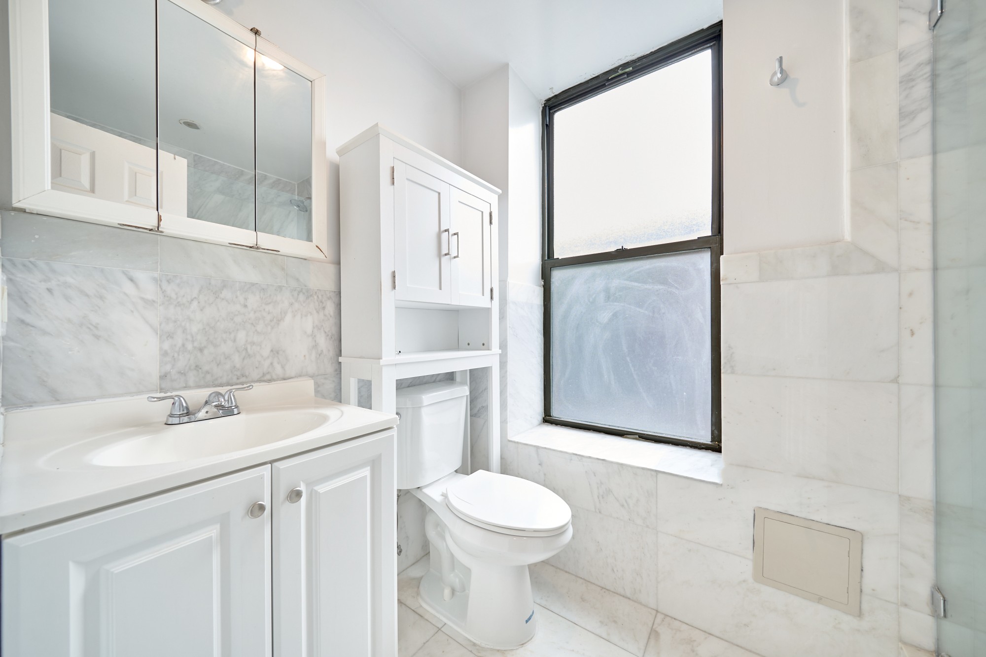 941 Columbus Avenue, Unit 1A Manhattan, NY 10025 - Photo 13 of 14 a bathroom with a sink toilet and shower