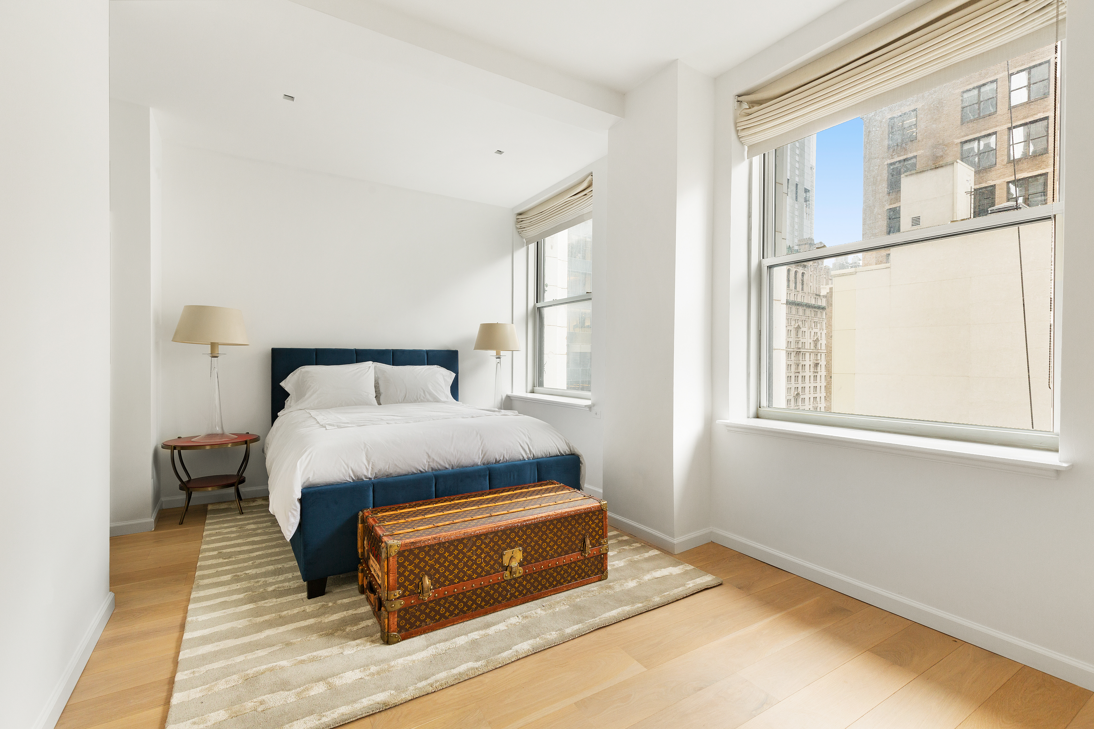 55 Liberty Street, Unit 15 Manhattan, NY 10005 - Photo 22 of 25 a bedroom with a bed and wooden floor
