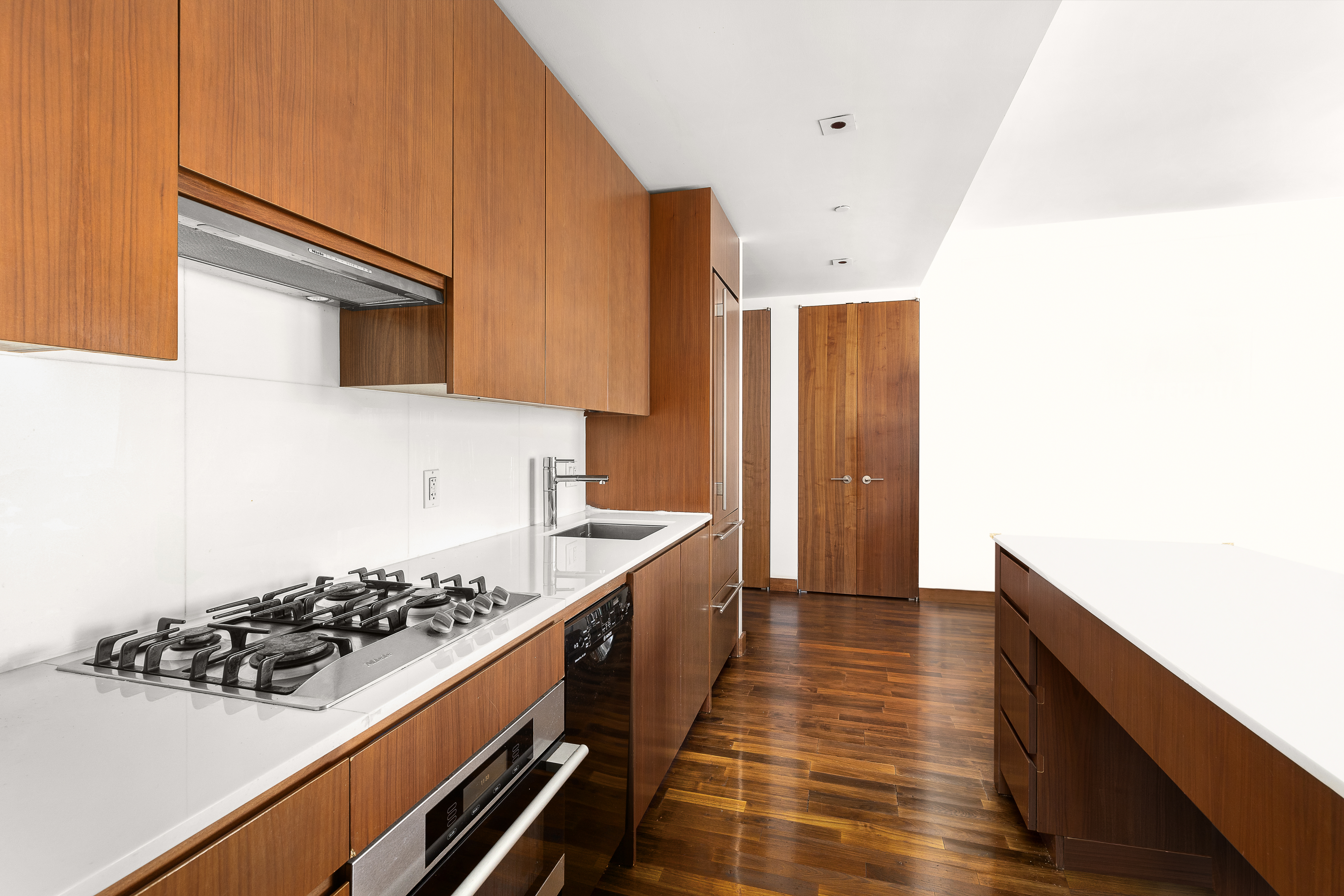400 5th Avenue, Unit 50F Manhattan, NY 10018 - Photo 4 of 8 a kitchen with a sink and wooden floor