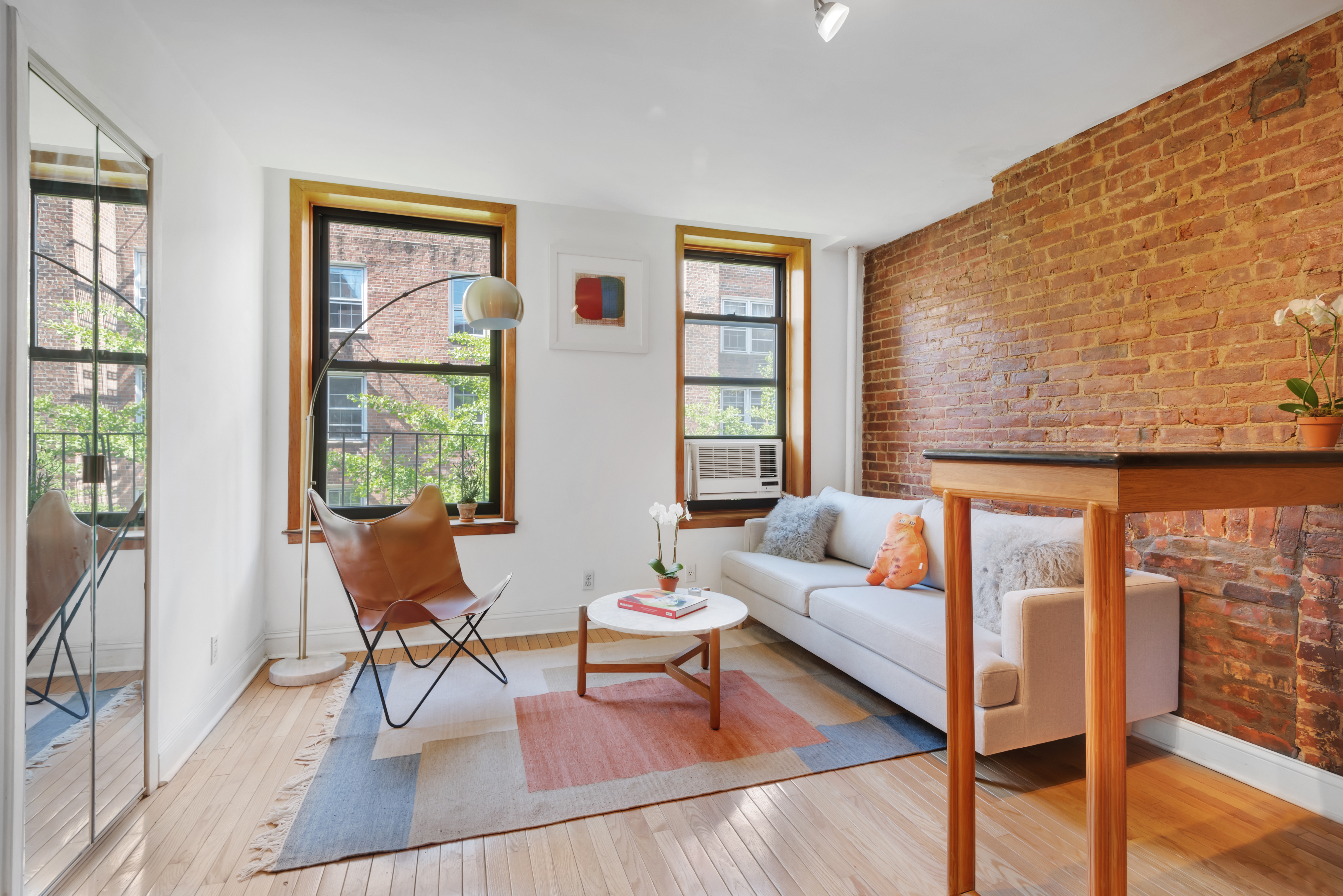 220 East 82nd Street, Unit 4RW Manhattan, NY 10028 - Photo 2 of 11 a living room with furniture and a window