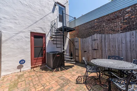 a view of backyard with a table and chairs