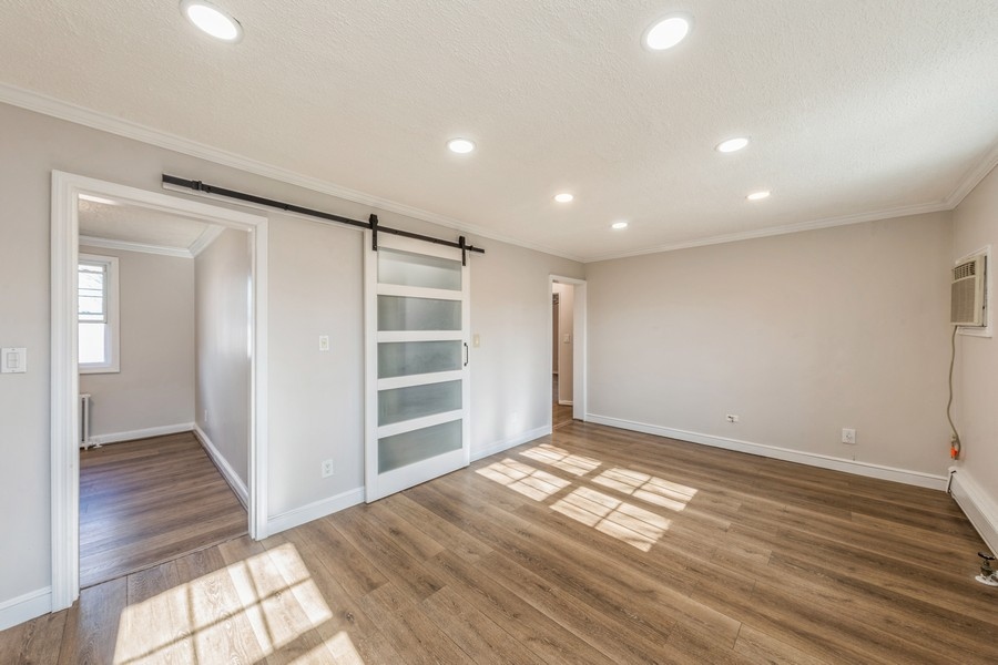 224-46 Horace Harding Expressway, Unit 630 Queens, NY 11364 - Photo 6 of 29 a view of empty room with wooden floor and window