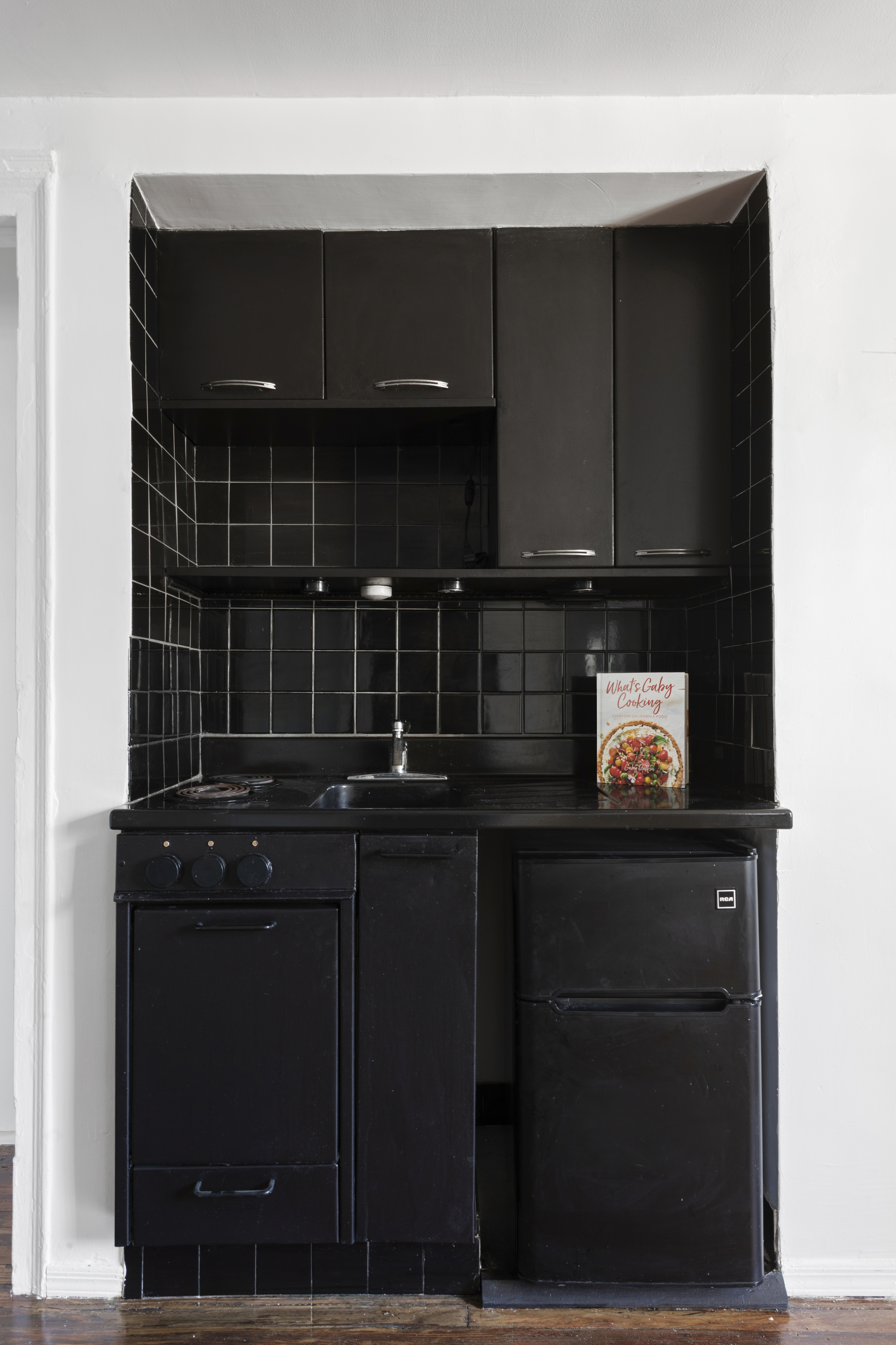 45 Tudor City Place, Unit 1808 Manhattan, NY 10017 - Photo 5 of 10 a kitchen with a sink and cabinets