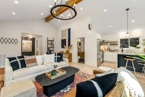 a living room with furniture and kitchen view