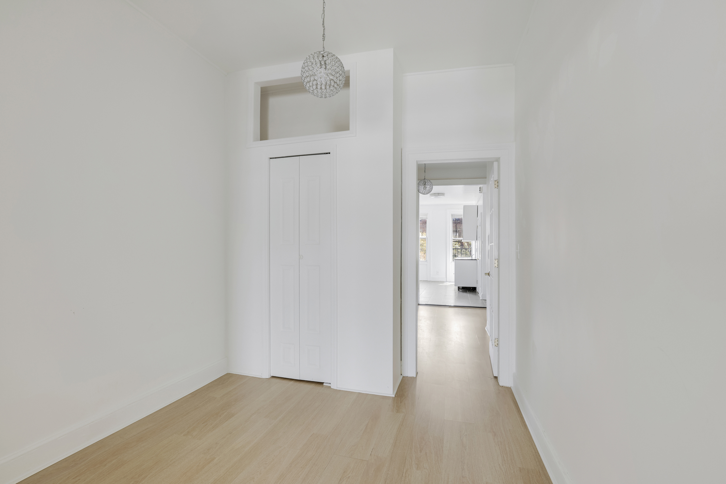 100 Powers Street, Unit 3L Brooklyn, NY 11211 - Photo 8 of 17 a view of a hallway with wooden floor and a bathroom