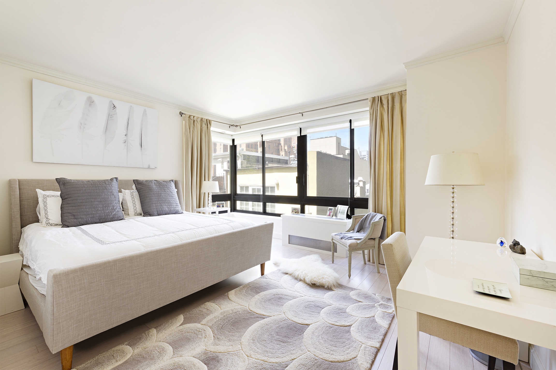 167 East 61st Street, Unit 7C Manhattan, NY 10065 - Photo 2 of 7 a living room with furniture and large windows