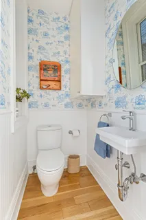 a bathroom with a toilet sink and mirror