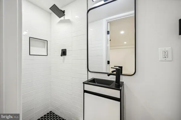 a bathroom with a sink and mirror