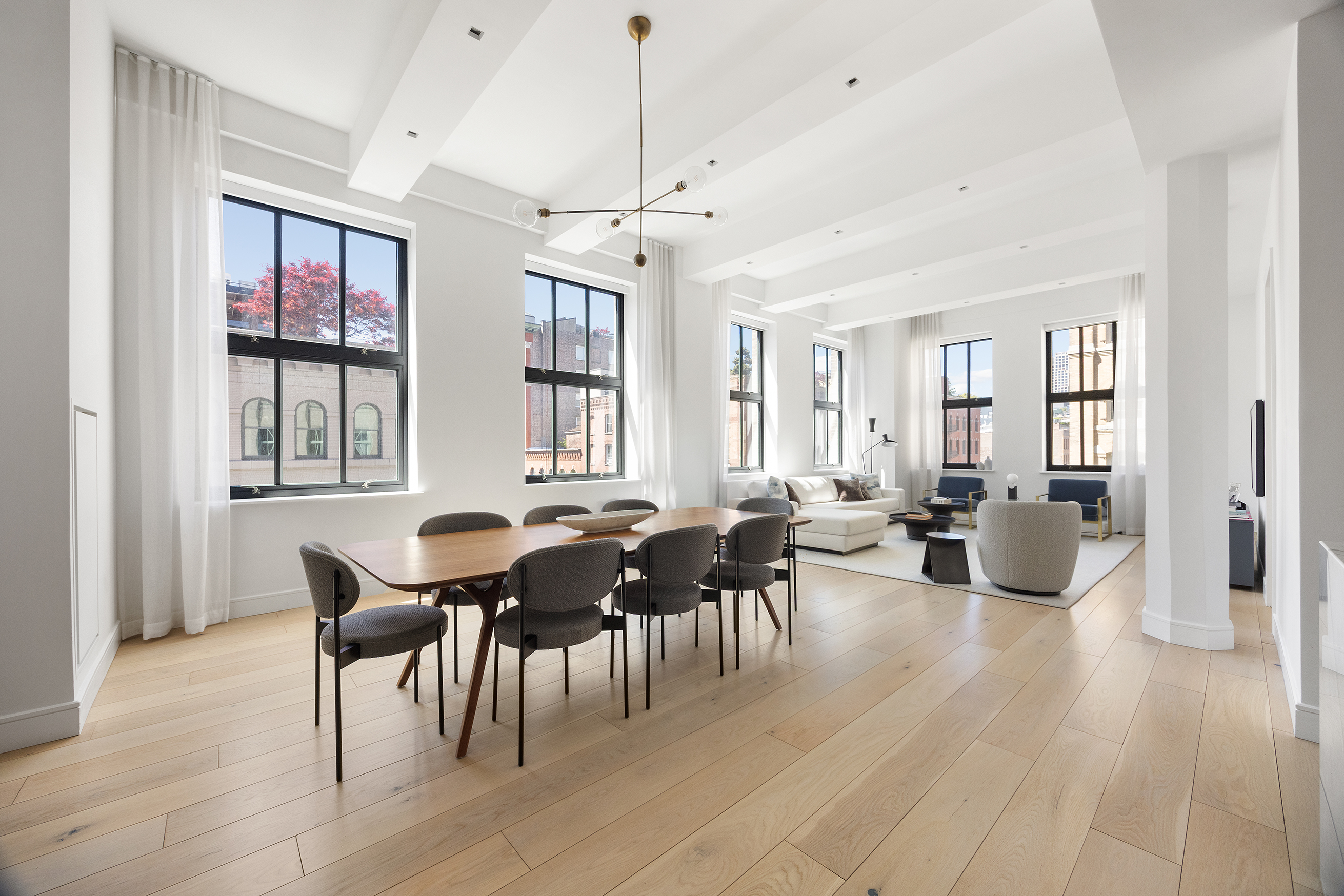 a living room with furniture a dining table and wooden floor
