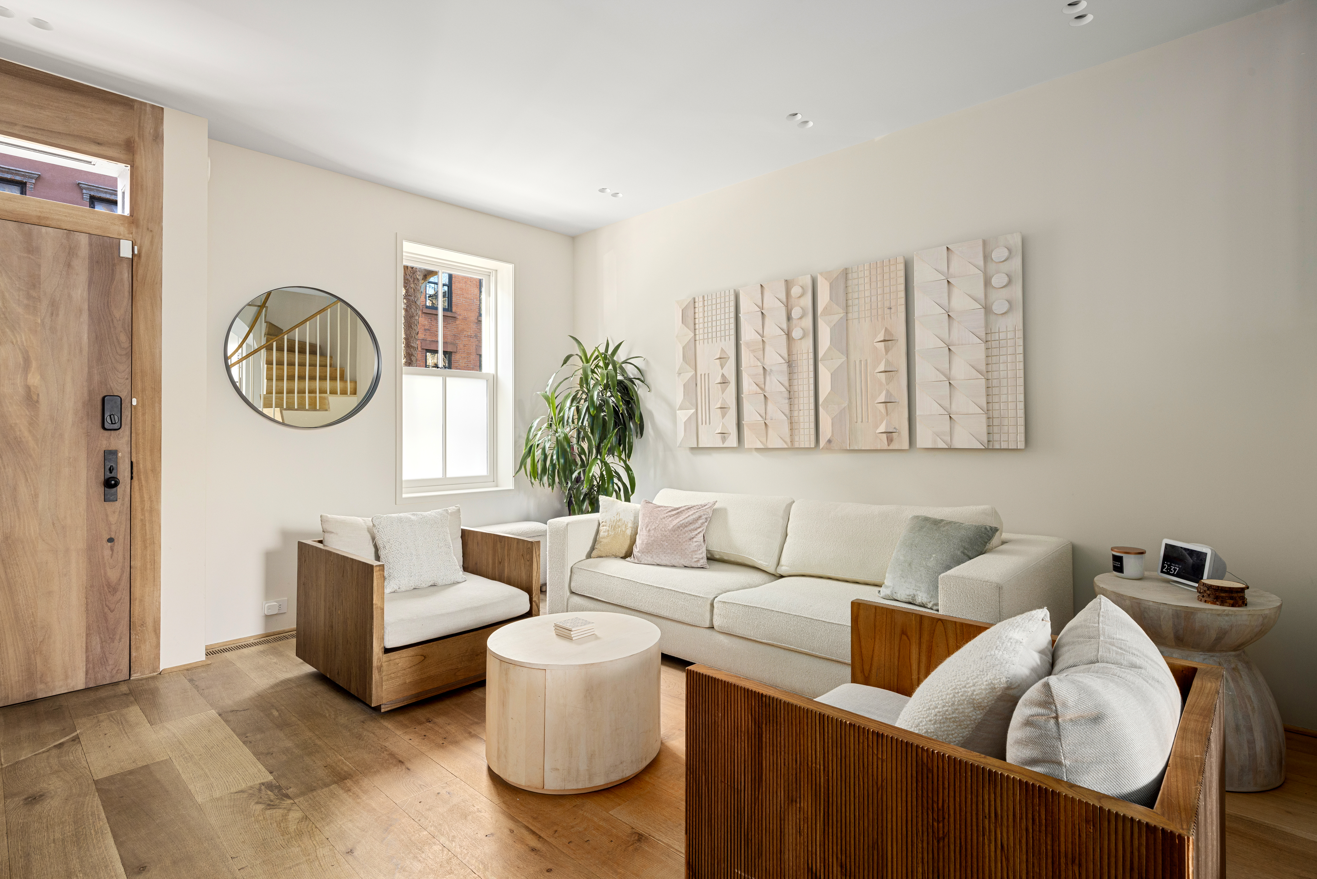 159 Hoyt Street Brooklyn, NY 11217 - Photo 11 of 18 a living room with furniture a clock and a window