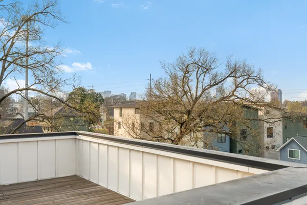 a view of balcony with wooden floor and fence