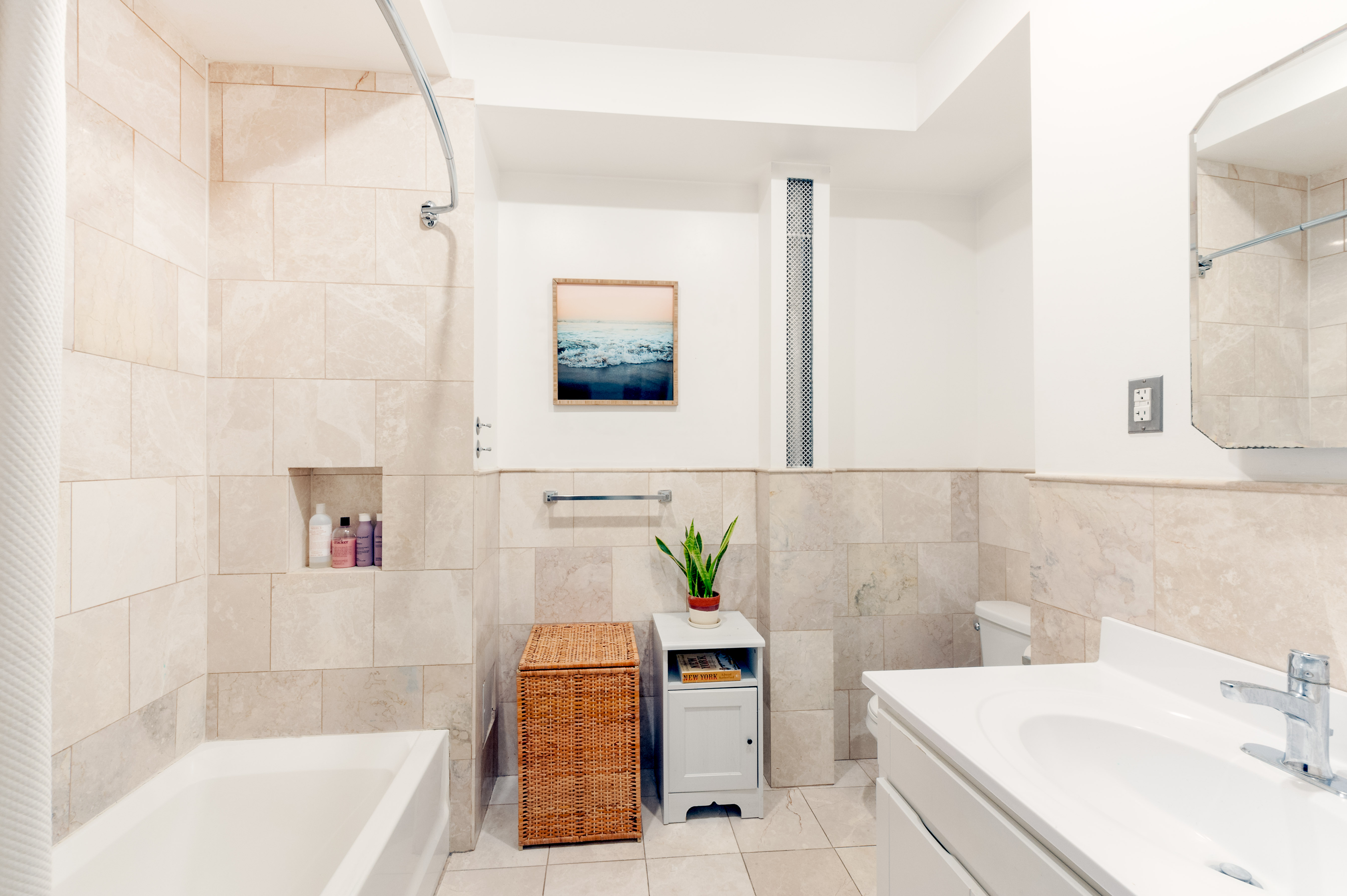 339 West 20th Street, Unit 3R Manhattan, NY 10011 - Photo 5 of 6 a bathroom with a tub sink and mirror