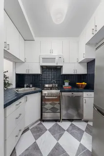 a kitchen with stainless steel appliances granite countertop a sink and cabinets