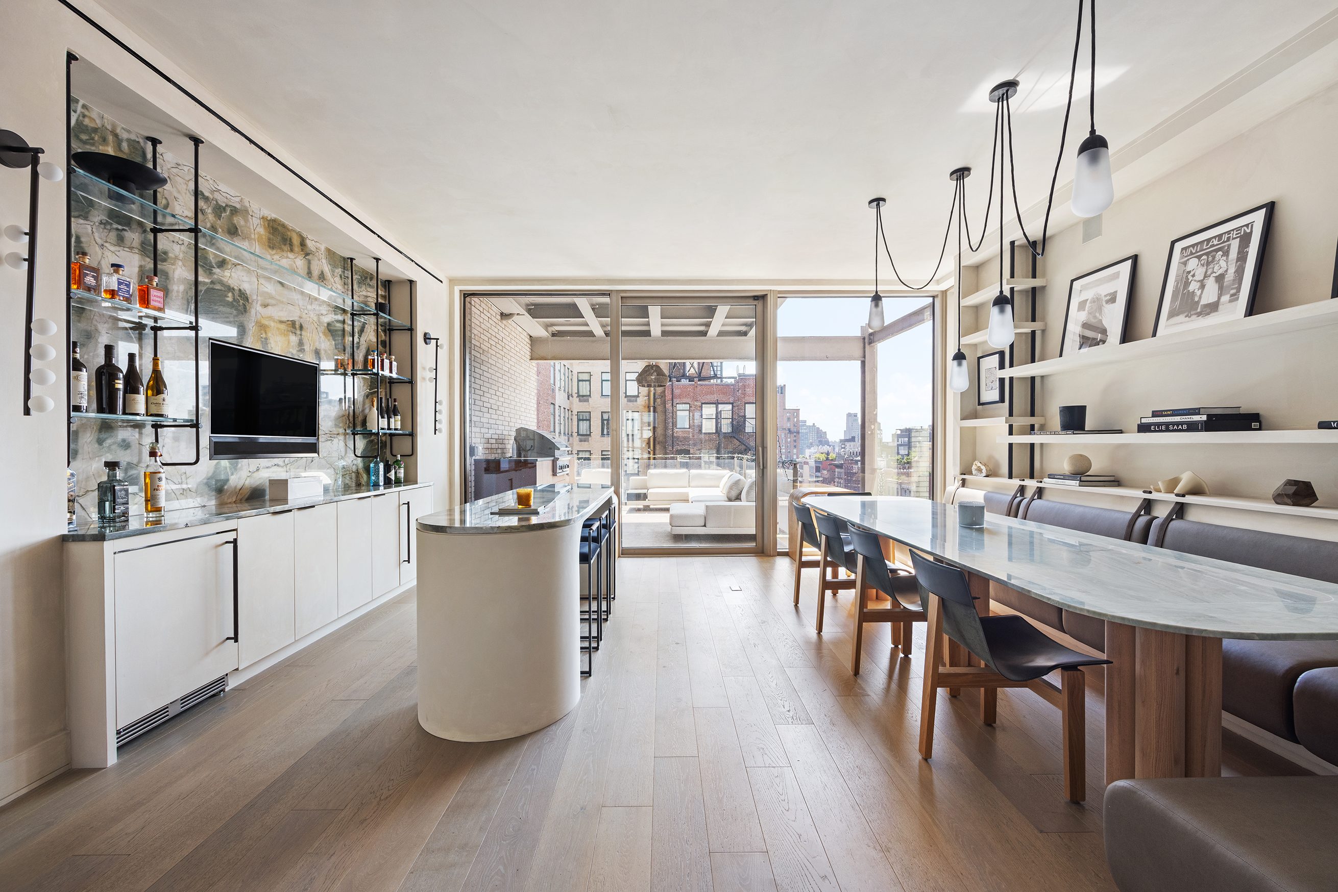 1 Great Jones Alley, Unit 10 Manhattan, NY 10012 - Photo 10 of 41 a kitchen with a table chairs microwave and stove
