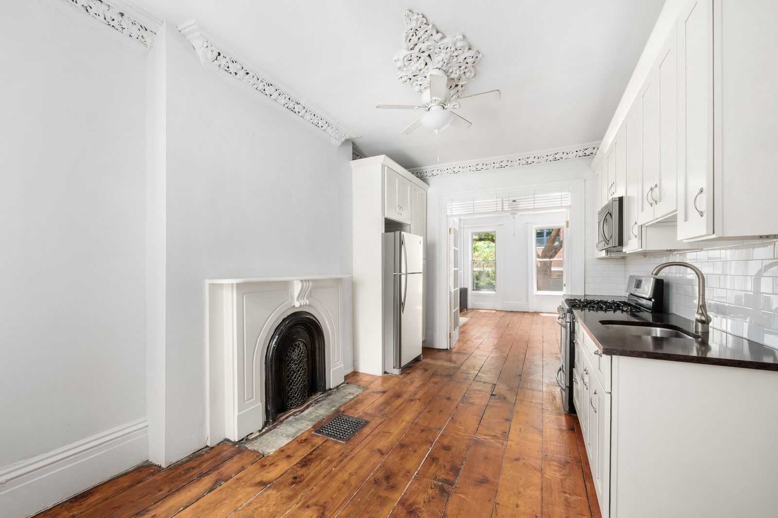 441 Union Street, Unit 2 Brooklyn, NY 11231 - Photo 2 of 11 a view of a kitchen with a stove wooden floor and a window