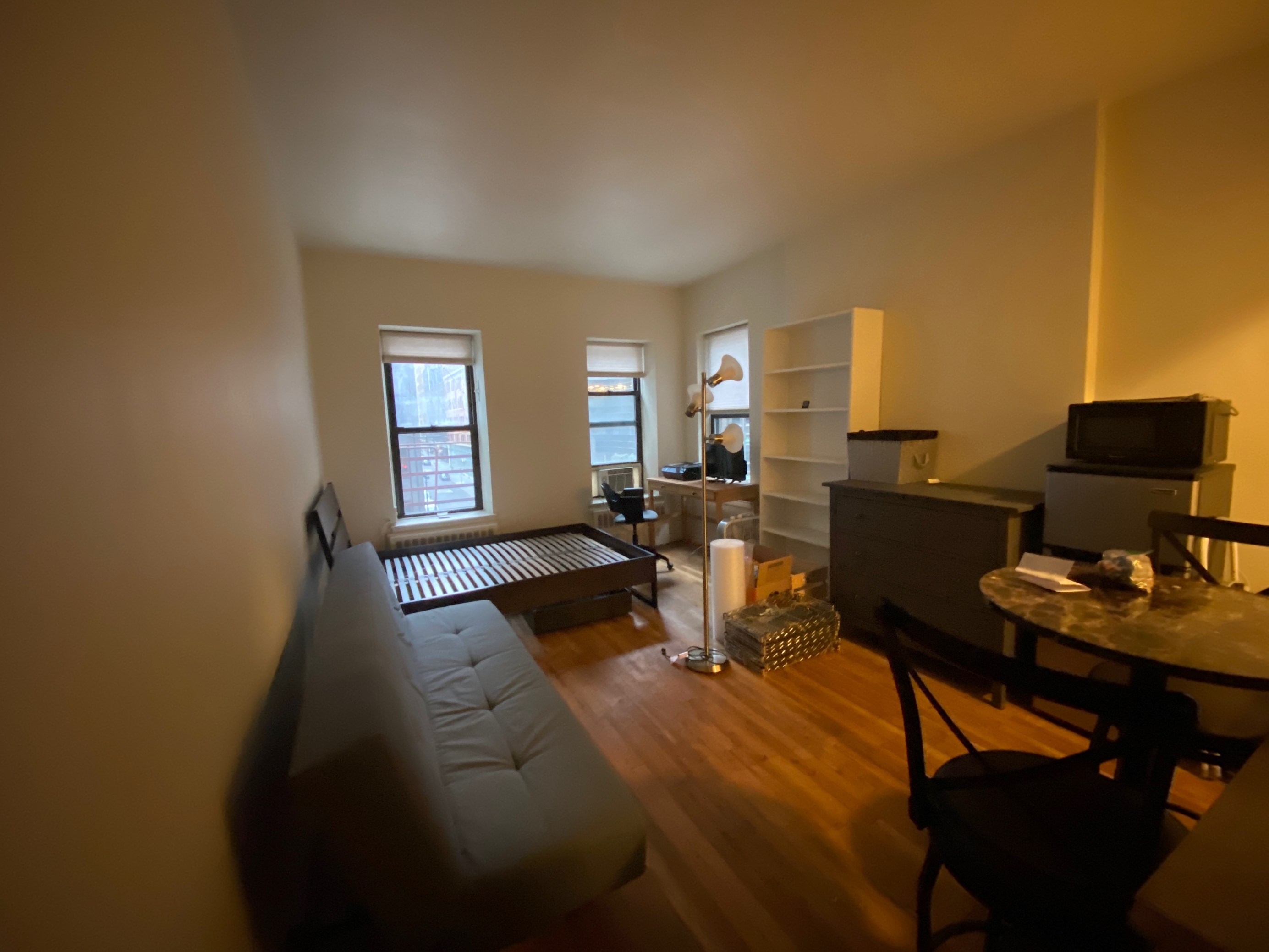 153 East 43rd Street, Unit 5A Manhattan, NY 10017 - Photo 3 of 7 a living room with furniture and wooden floor