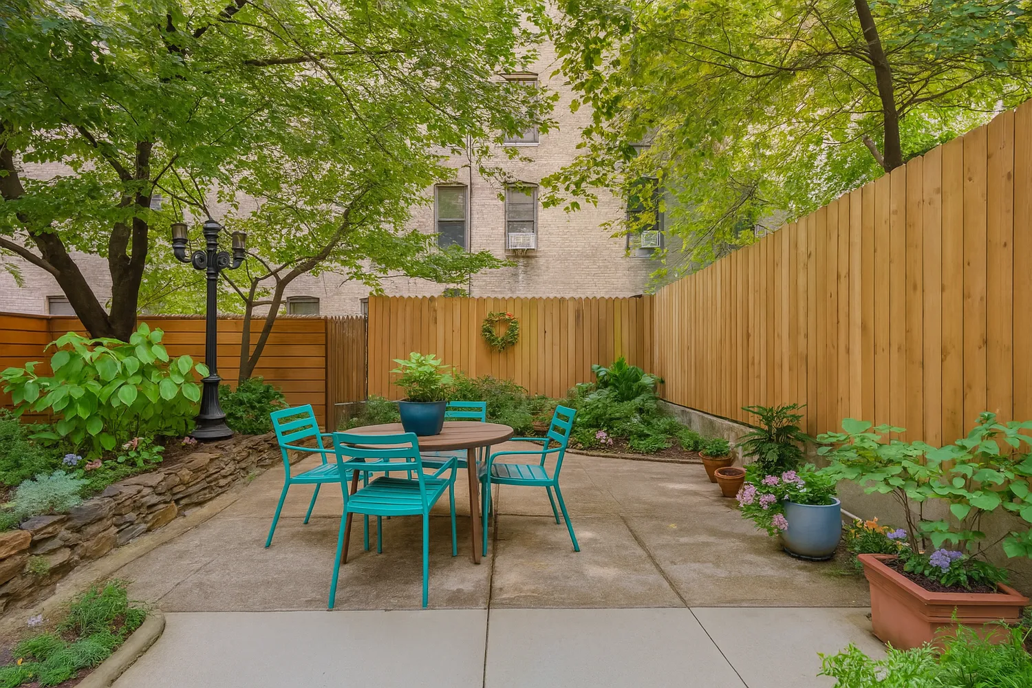 a patio with table and chairs and potted plants