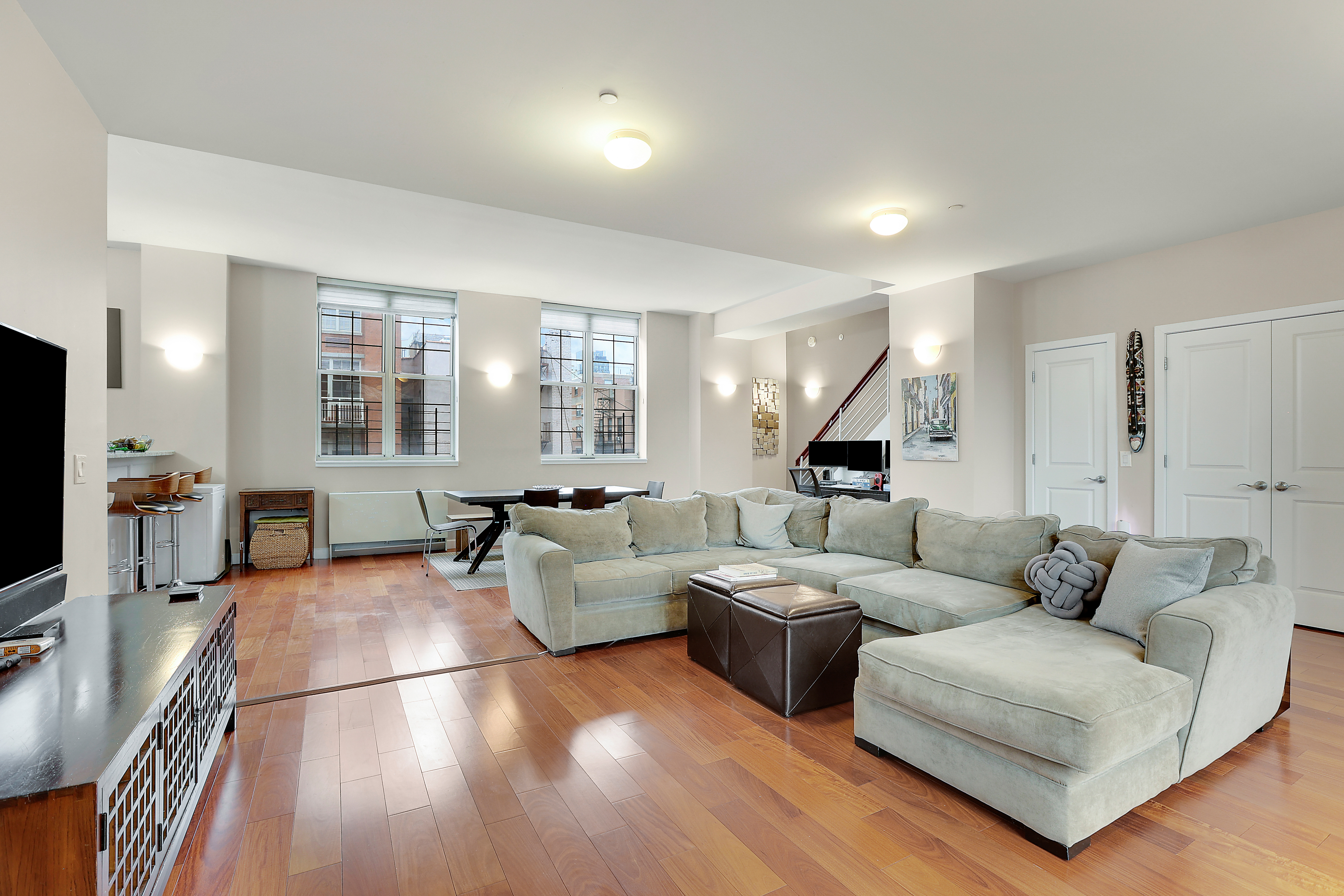 313 West 119th Street, Unit PHE Manhattan, NY 10027 - Photo 5 of 19 a living room with furniture wooden floor and a flat screen tv