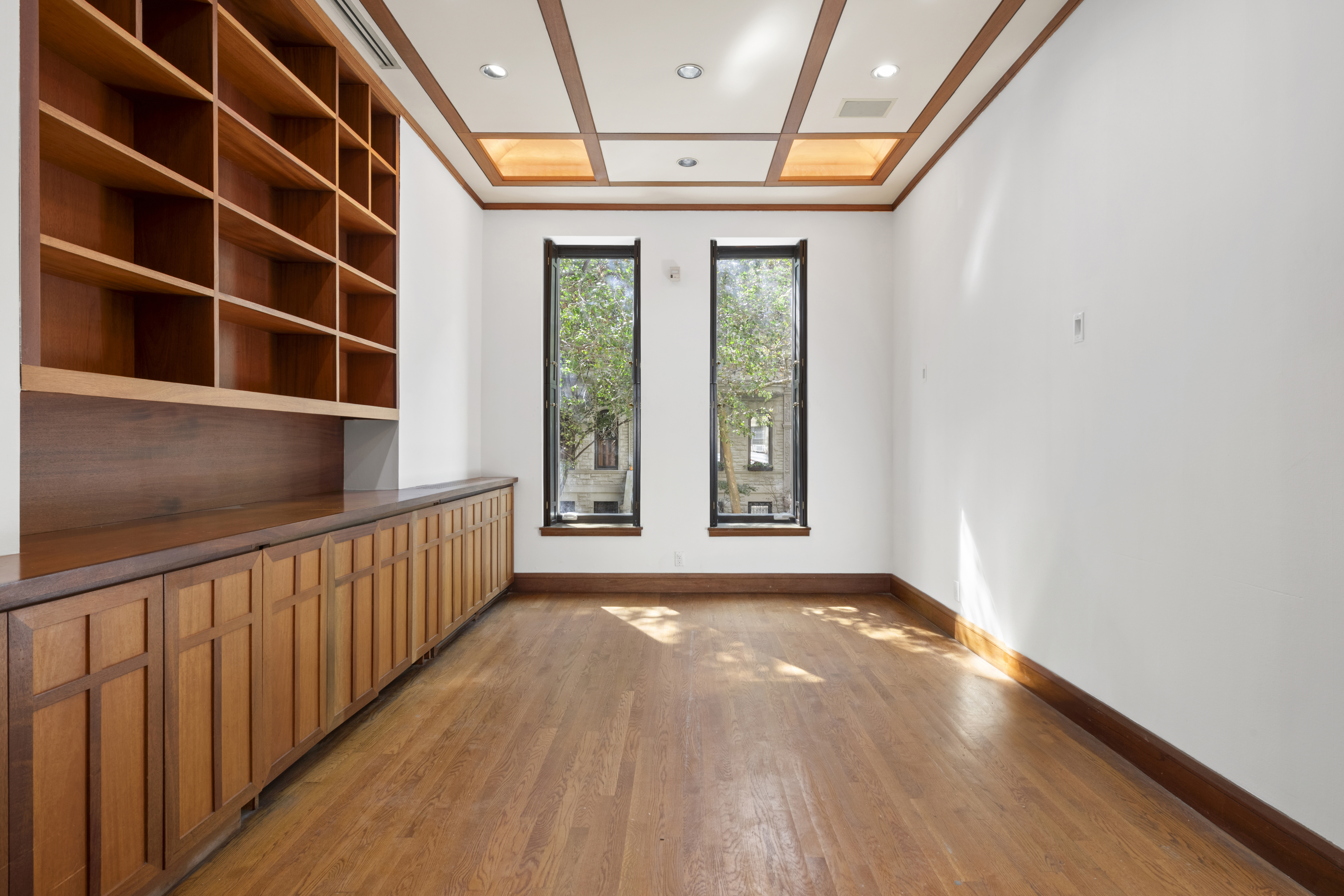 313 West 102nd Street Manhattan, NY 10025 - Photo 10 of 36 a view of an empty room with a window and wooden floor