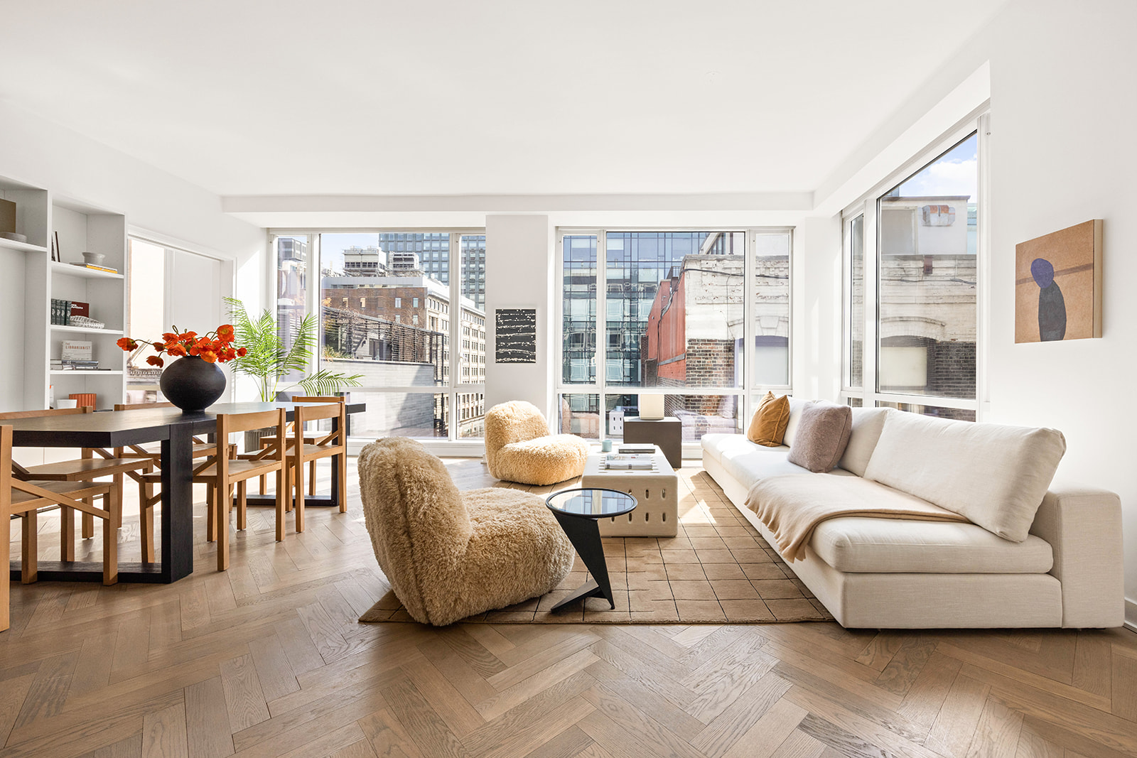 a living room with furniture a chandelier and a large window