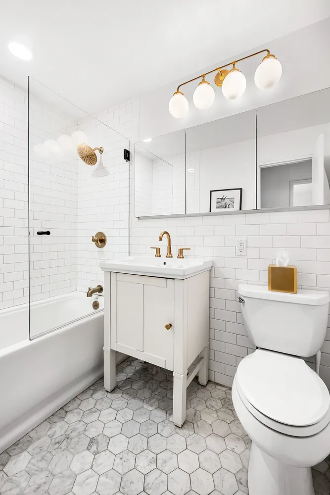 a bathroom with a sink a toilet and bathtub