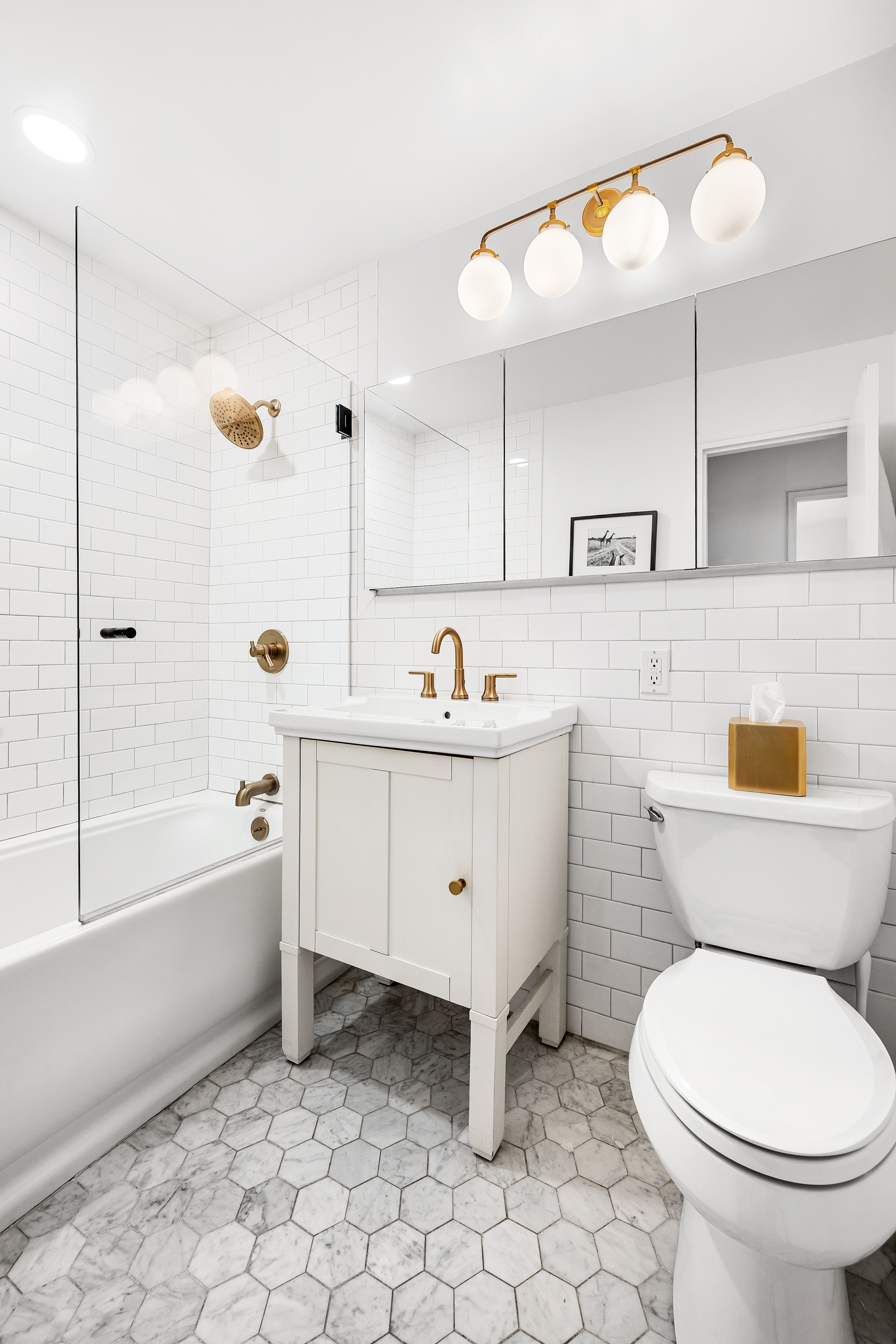 165 Christopher Street, Unit 5DD Manhattan, NY 10014 - Photo 11 of 15 a bathroom with a sink a toilet and bathtub