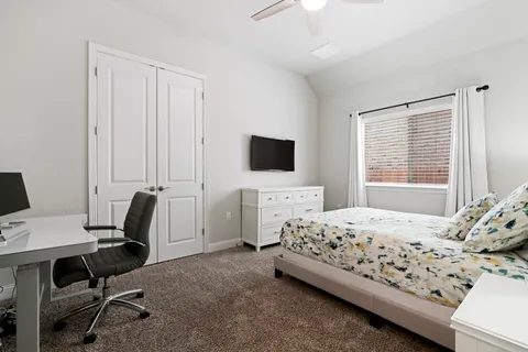 a room with a bed and a book shelf