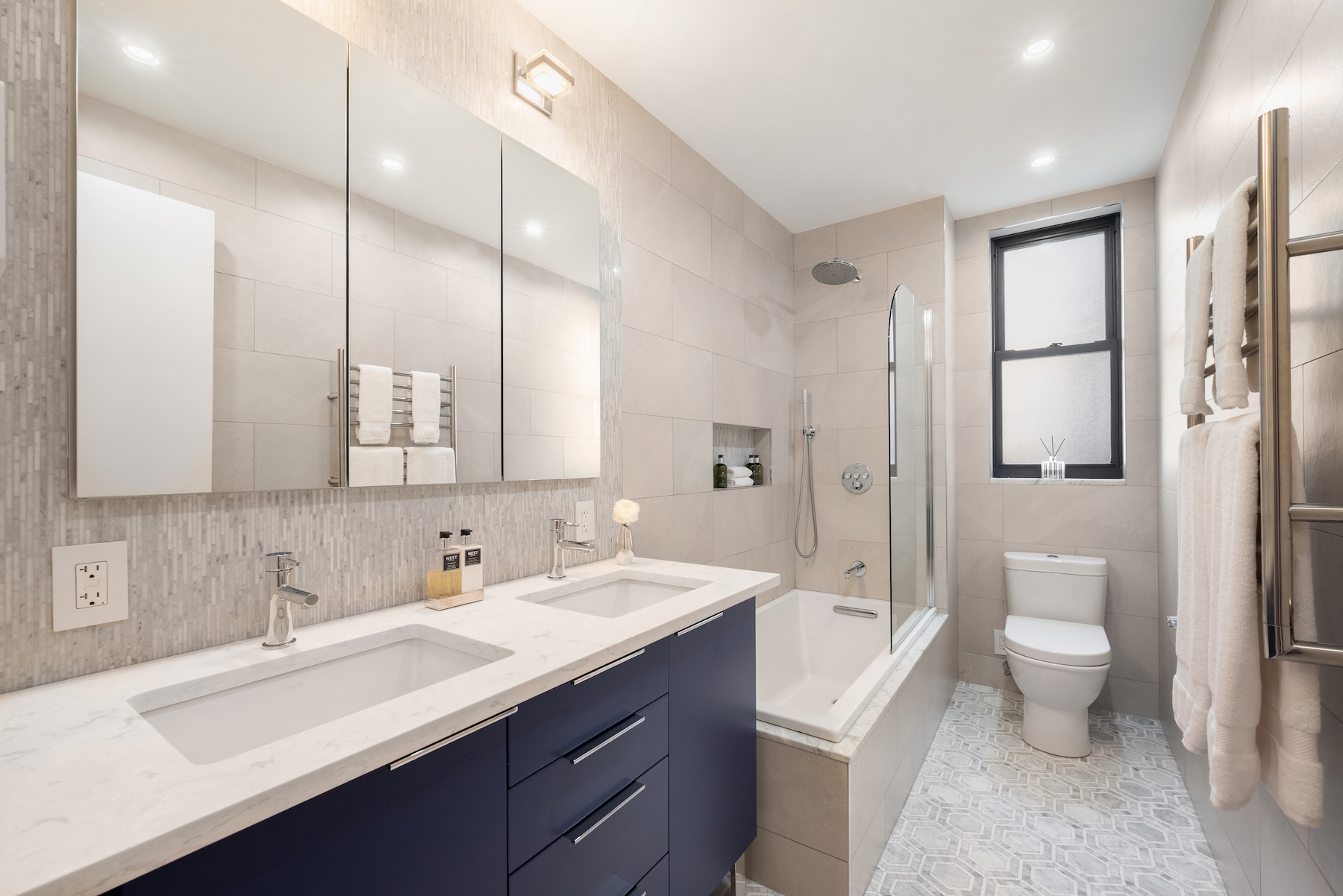 440 West End Avenue, Unit 2E Manhattan, NY 10024 - Photo 7 of 12 a bathroom with a sink a toilet and shower