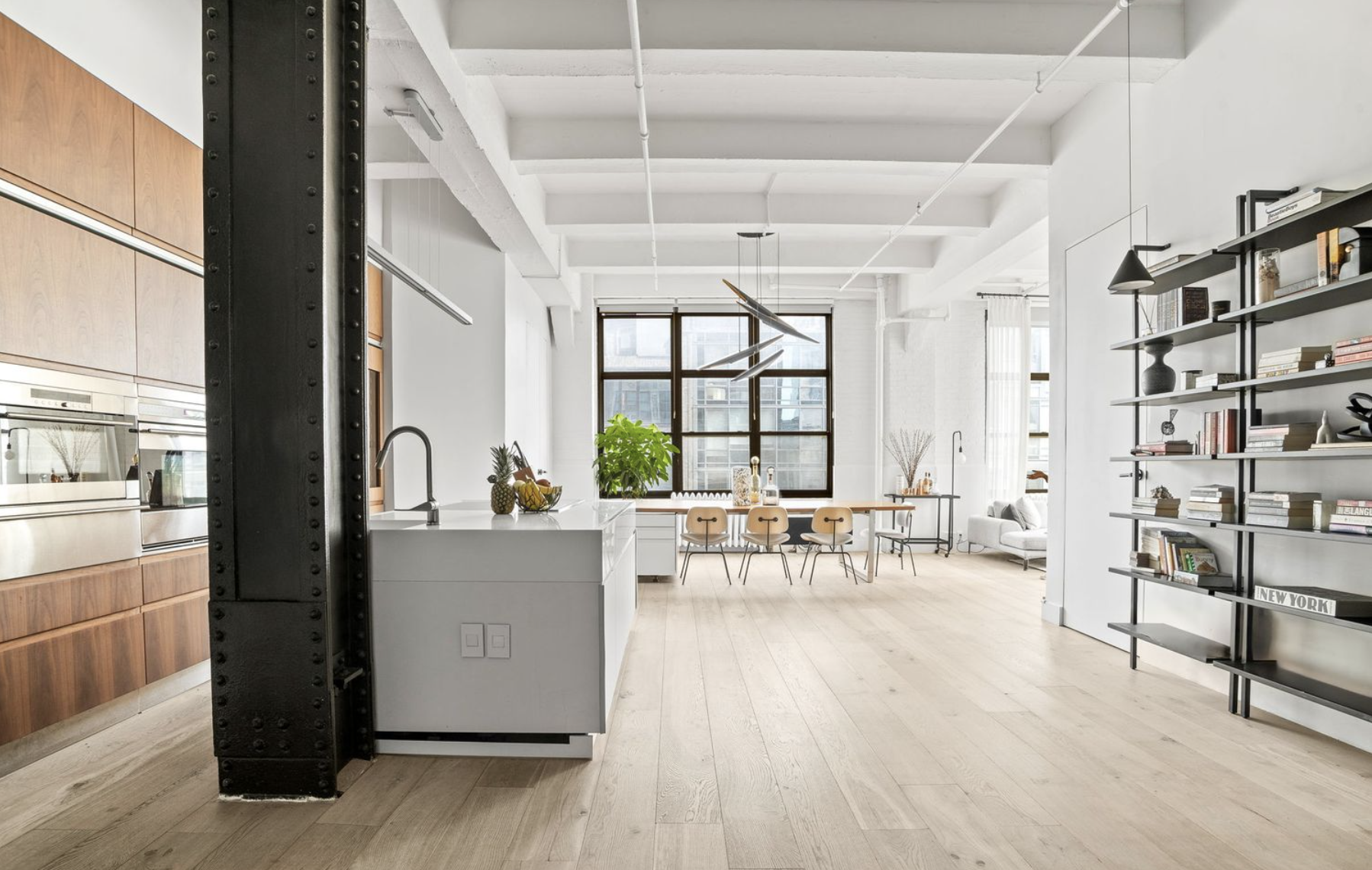 448 West 37th Street, Unit 8C Manhattan, NY 10018 - Photo 2 of 10 a living room with furniture and a large window